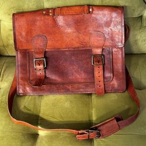 Handmade leather crossbody messenger bag with adjustable, padded strap.